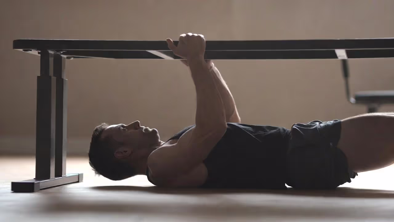 Athlete performing an inverted row with straight body alignment