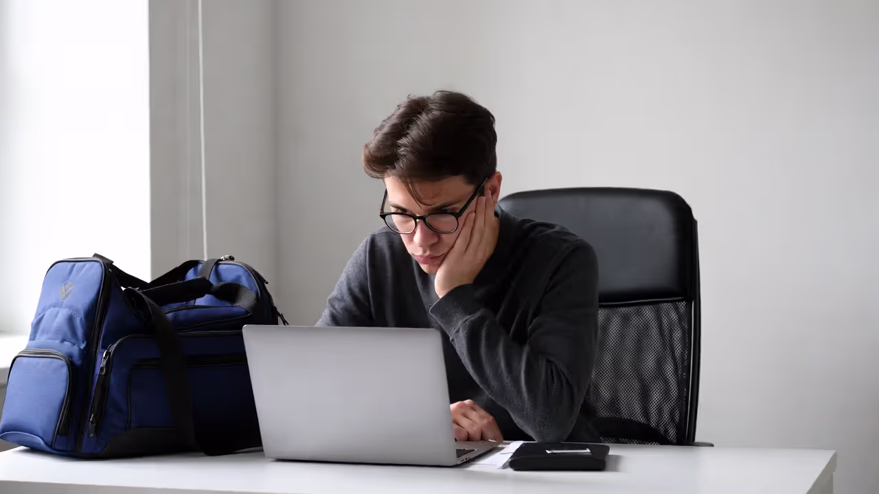Athlete looking mentally drained and unfocused at a desk during the day