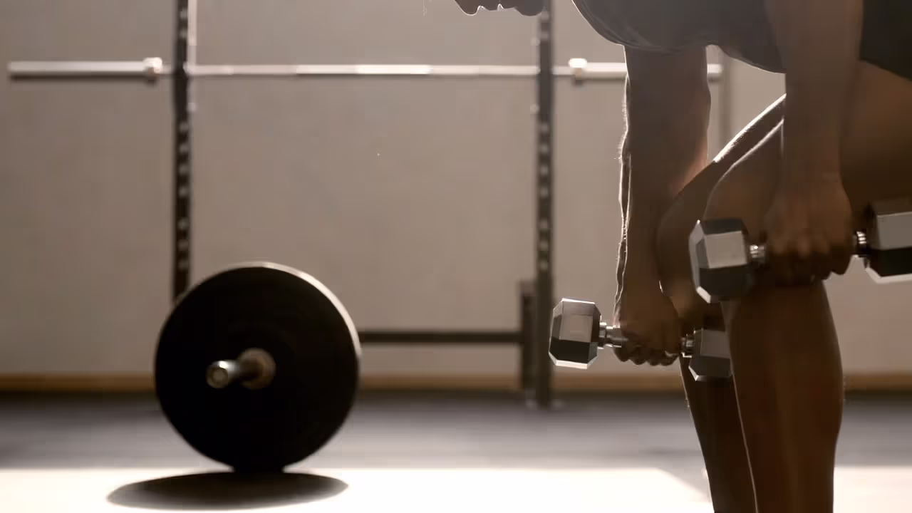 Athlete performing a controlled Romanian deadlift with proper form in a gym