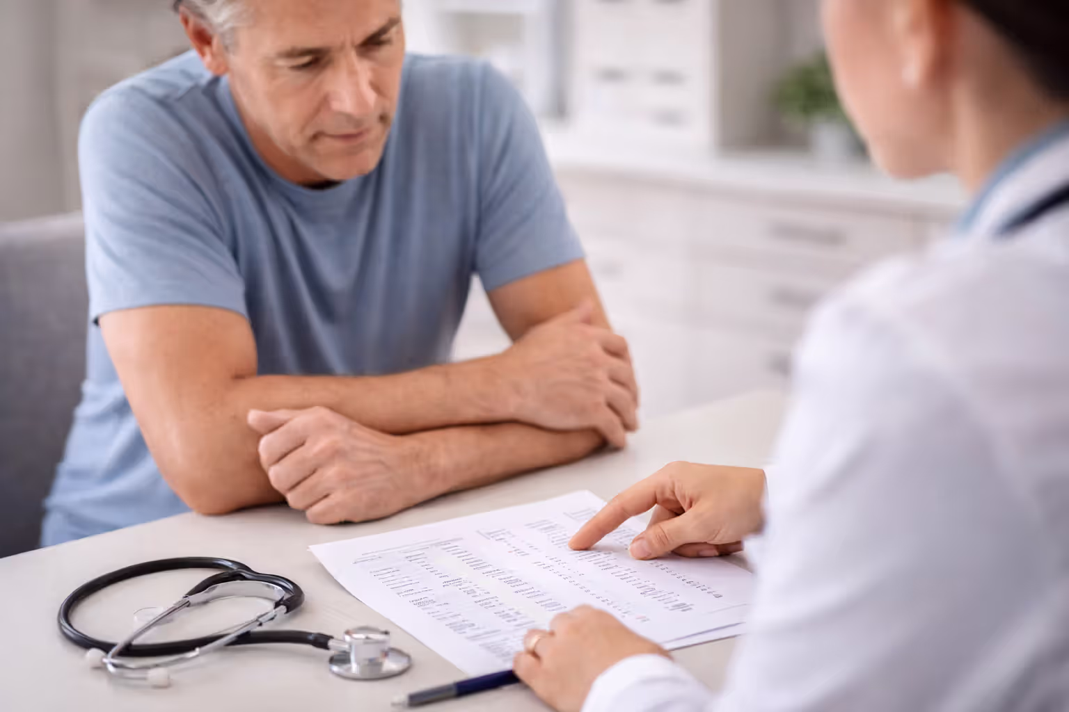 Patient reviewing blood test results with healthcare professional in a medical office