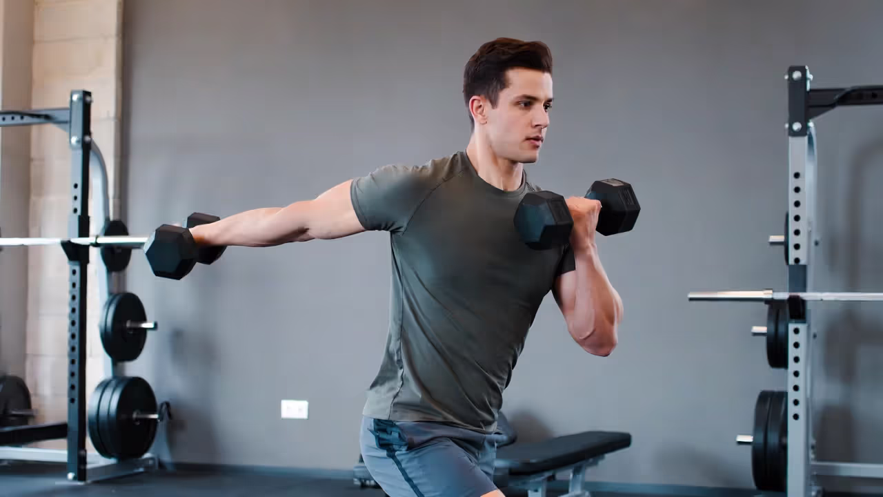 Person performing a strength training exercise with dumbbells