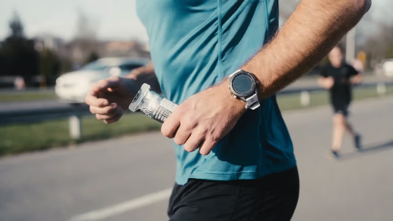 Runner practicing race fueling with energy gel during a long training run